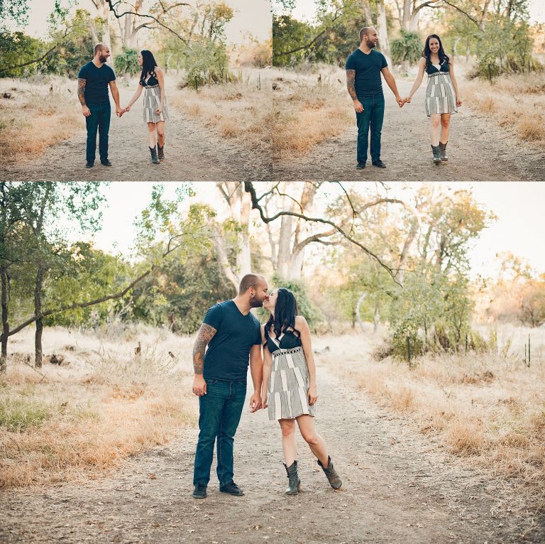 Long brown haired woman, tall tattooed man, standing by american river taking engagement photos