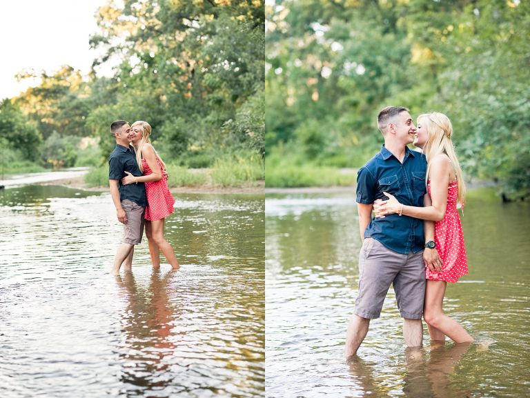 Hugging engaged couple he in khaki shorts and blue shirt, she in a red dress